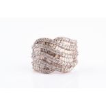 A 9ct yellow gold, white and cognac diamond cocktail ring the band set with sweeping lines of