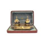 A late Victorian / Edwardian silver gilt inkstand with pierced gallery and repousse decoration the