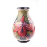 A mid-20th century Walter Moorcroft baluster vase in the Orchid pattern with tube-lined floral