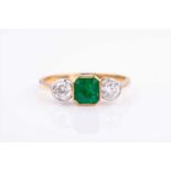 An 18ct yellow gold, diamond, and emerald ringcentred with a squared emerald-cut emerald of