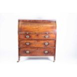 An early 19th century mahogany cylinder bureauthe cylinder top opening to reveal a fitted inteior