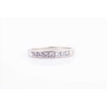 A 9ct white gold and diamond half eternity ringsize L 1/2, 2 grams.