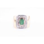 A yellow metal, diamond and emerald ringcentred with a bezel-set emerald, within a chamfered