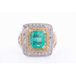 An impressive 18ct white and yellow gold, diamond, and emerald cluster ringcentred with a mixed