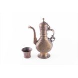 A Middle Eastern damascene brass teapot decorated with relief floral and foliate patterns throughout