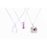 Two gem set 9 carat white gold pendants together with another white metal diamond set pendant