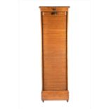 An early 20th century German light oak tambour fronted music cabinetthe large tambour panel