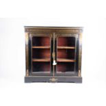 A 19th century brass mounted and inlaid ebonised cabinet the twin glazed doors flanked by cherub