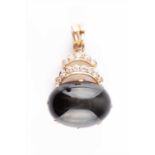 An unusual diamond and cats eye chrysoberyl pendant mounted in rose metal (marked 14K, tests as