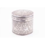 A Persian white metal tea caddyof circular form profusely decorated with engraved foliate motifs,