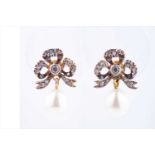 A pair of diamond and pearl drop earringsthe silver set gold-backed bow-shaped mounts inset with