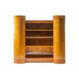 A Biedermeier style satinwood bookcase in the Art Deco taste with twin curved cupboard doors,