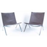 A pair of Paul Kjaerholm 'PK22' chairsfrom a 1956 design, in chrome and brown leather, bearing a