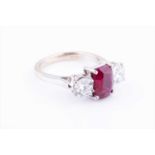 An 18ct white gold, diamond, and ruby ringcentred with a mixed oval-cut ruby of approximately 1.86