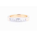 An 18ct yellow gold and diamond band ringset with seven square-cut diamonds, size L 1/2, 5.4 grams.