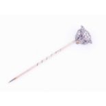 A diamond-set stick pinin the form of a wolf's head, with ruby eyes, head 14 mm wide, pin 6.3 cm