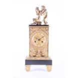A late 19th century brass mounted French mantel clock surmounted by a pair of children, the face