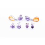 A pair of cabochon amethyst stud earrings, stamped Garrard 750together with a pair of amethyst and