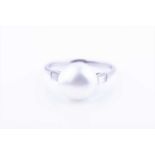 A natural pearl and diamond ringset with a rounded natural white saltwater pearl of approximately