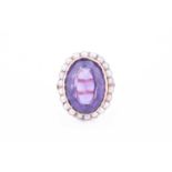 A yellow metal, amethyst, and pearl cluster ringset with a mixed oval-cut amethyst, within a