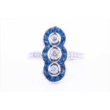 An 18ct white gold, diamond, and sapphire ringin the Art Deco style, the north to south mount