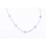 A white metal and diamond chain necklaceset with nineteen open-set round-cut stones, no clasp,