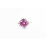 A yellow metal, diamond, and ruby cluster ringset with four round-cut rubies and small diamonds, the