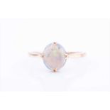 An 18ct yellow gold and opal ringset with a single oval cabochon opal, measuring approximately 9 x 8