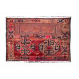 A small late 19th century Iranian wool rug decorated in sections with geometric shapes and a reserve