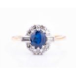 An 18ct yellow gold, diamond and sapphire cluster ringset with a mixed oval-cut blue sapphire within