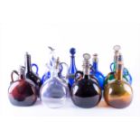A collection of thirteen coloured glass decantersmost early 20th century, comprising blue, purple,