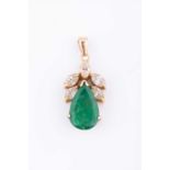 A yellow metal, diamond, and emerald pendantset with a mixed pear-cut emerald, surmounted with