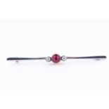 A 15ct yellow gold, diamond, and ruby bar broochcentred with a collet-set mixed round-cut ruby,