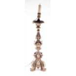 A large carved neoclassical style candlestick / converted lamp with moulded decoration, on three