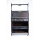 An attractive 19th century ebonised bureau in the Aesthetic taste the upper railed shelf with