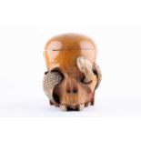 An unusual Chinese skull shaped carved boxwood and bone boxin the form of a skull with an entwined