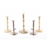 A collection of Georgian brass candlesticksto include a pair of side ejector candlesticks with