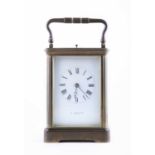 A brass chiming and repeating carriage clock the white enamel dial with Roman numerals inscribed "