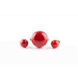 A striking yellow metal and coral cocktail ring, set with a large polished red cabochon coral, the