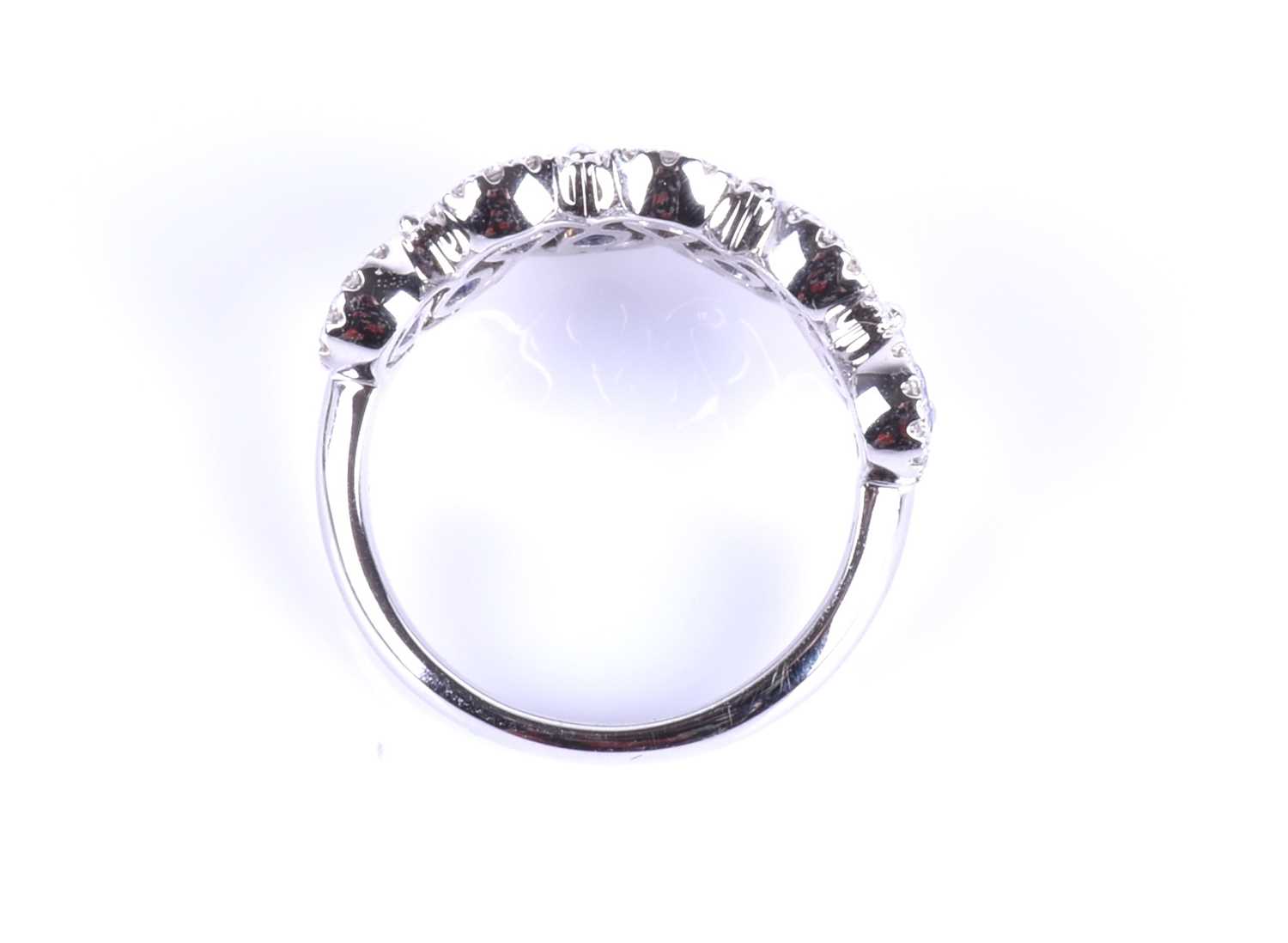 An 18ct white gold, diamond and sapphire ring, the rounded mount set with a row of mixed pear-cut - Image 2 of 8