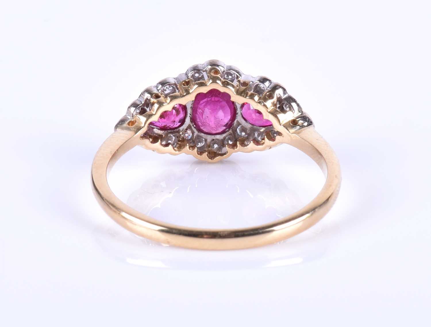 An 18ct yellow gold, diamond and ruby ring, centred with a mixed oval-cut ruby flanked with two - Image 3 of 4