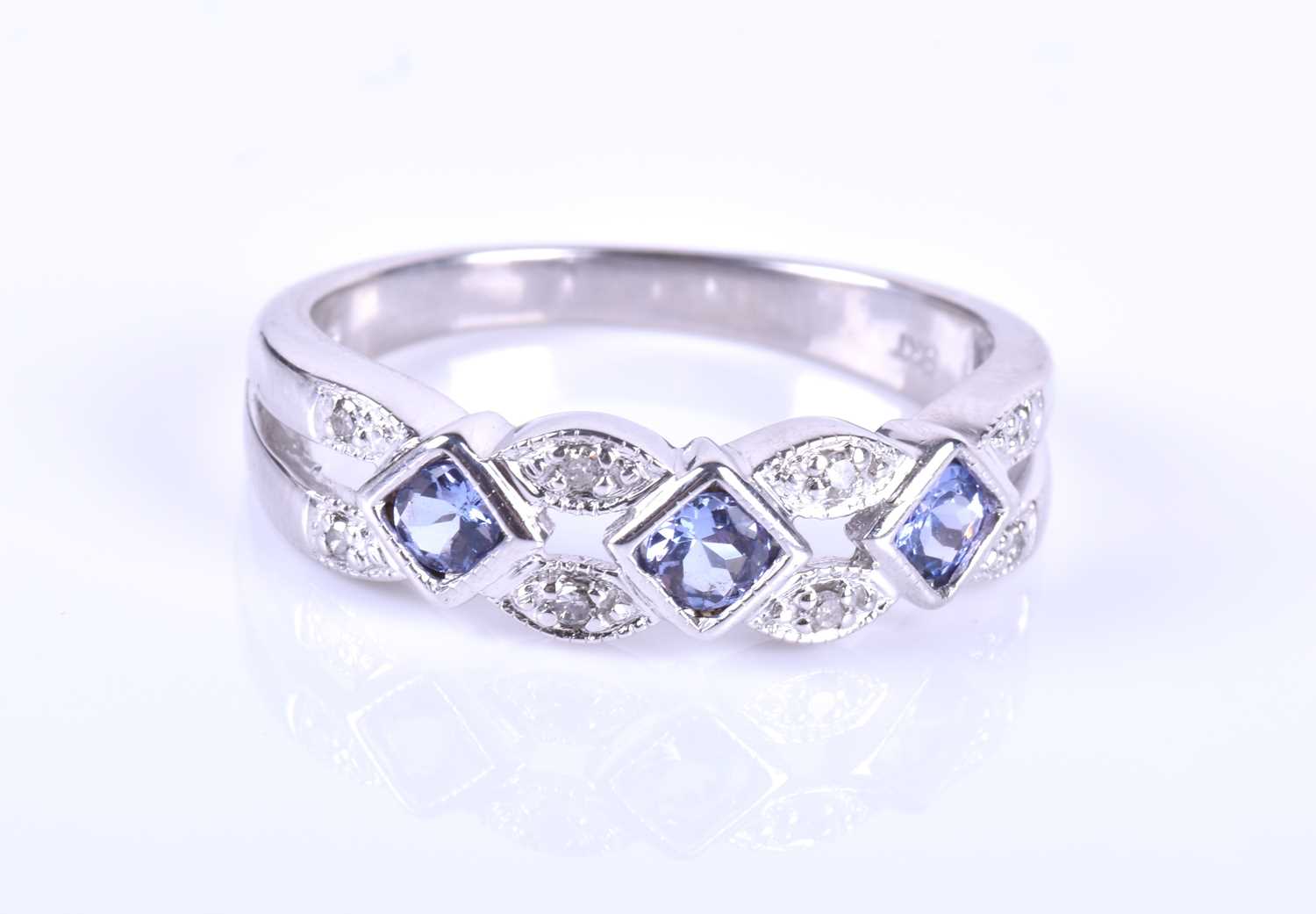 A diamond and tanzanite ring, the openwork mount set with square-cut pale blue tanzanites, - Image 4 of 5