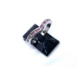 An 18ct white gold, pink sapphire and diamond wishbone ring, set with seven channel-set brilliant
