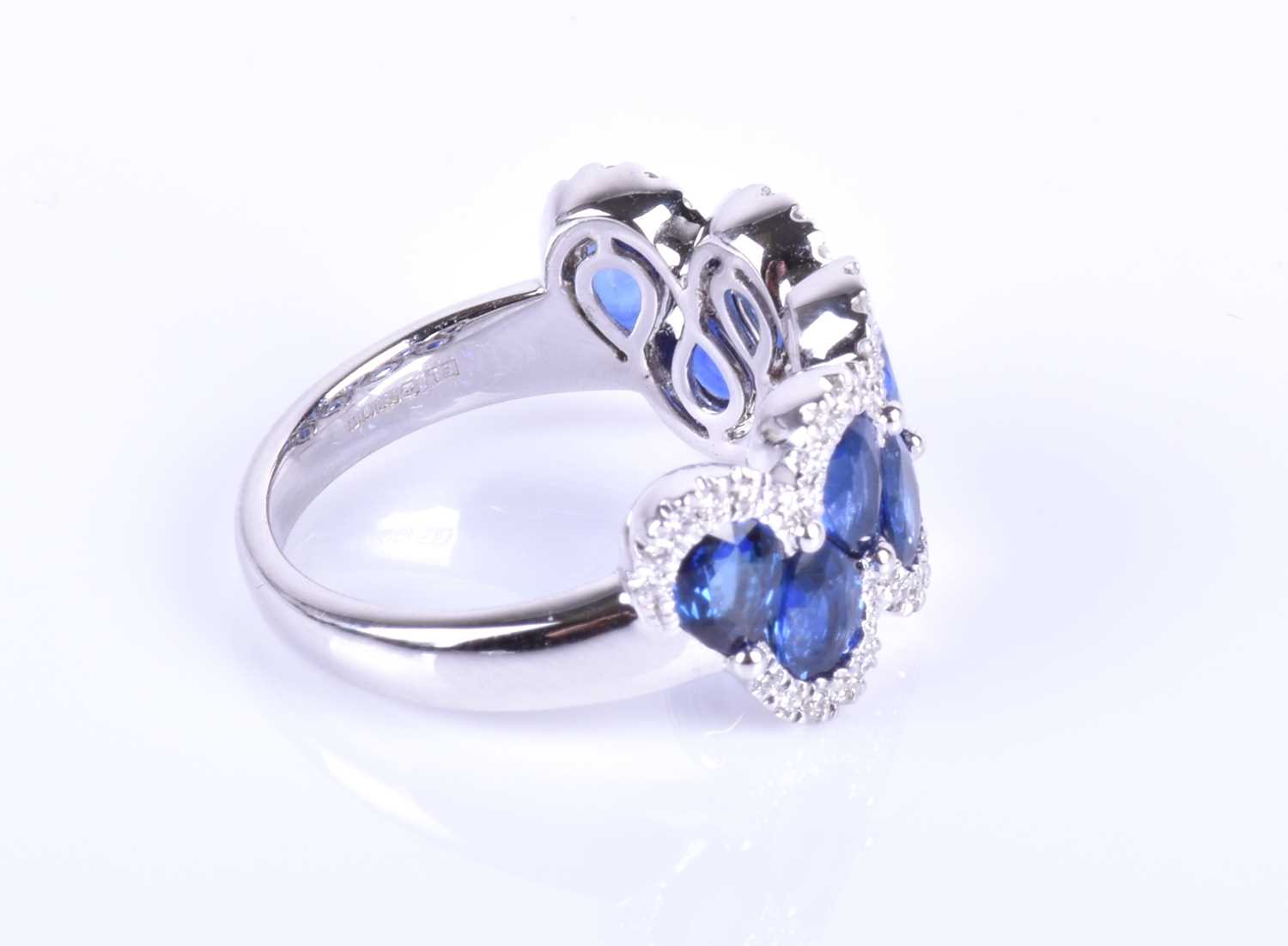 An 18ct white gold, diamond and sapphire ring, the rounded mount set with a row of mixed pear-cut - Image 4 of 8