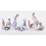 A group of five Lladro porcelain figures, comprising a girl painting, a girl and a puppy, a