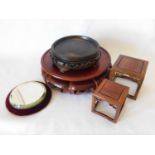 Four oriental hard wood vase stands, an ebonised circular example circa 1880/1900, with pierced