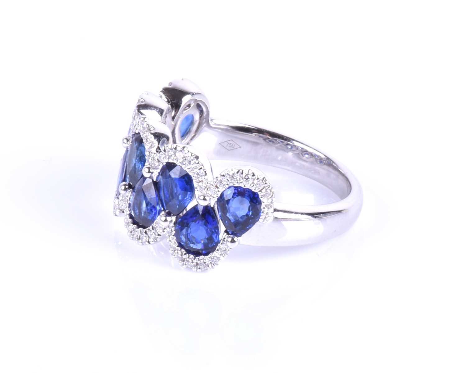 An 18ct white gold, diamond and sapphire ring, the rounded mount set with a row of mixed pear-cut - Image 8 of 8