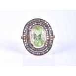 A 14ct gold, silver, diamond and green gemstone ring, centred with a mixed oval-cut stone,