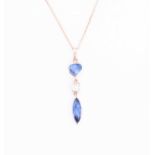 An 18ct rose gold, diamond and sapphire pendant, set with a mixed pear-cut sapphire, a baguette-