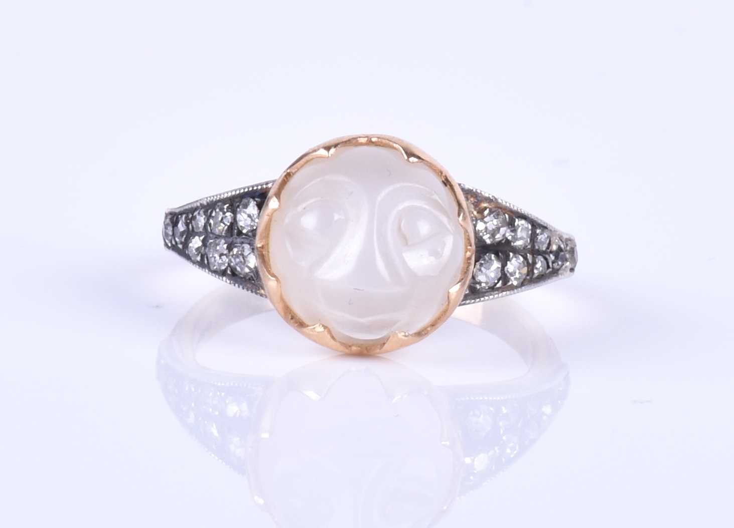 An unusual carved moonstone ring, centred with a moonstone carved in the form of a face, the tapered - Image 7 of 7